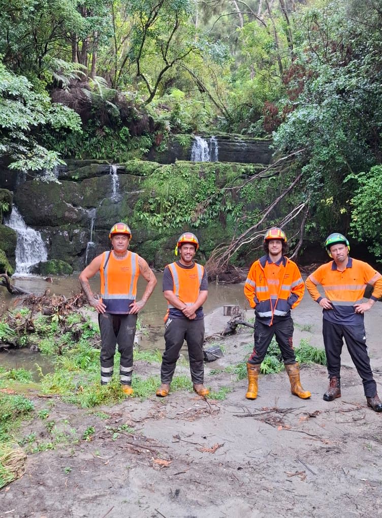 Hop Sadlier and the Eastland Tree Care crew standing in front of a waterfall